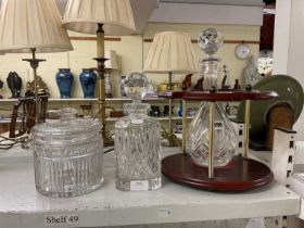 Two glass decanters, one with stand, height of largest 33cm, also a cut glass lidded jar.