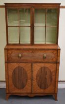 A Regency satinwood rosewood crossbanded and inlaid secretaire bookcase, the two door glazed upper