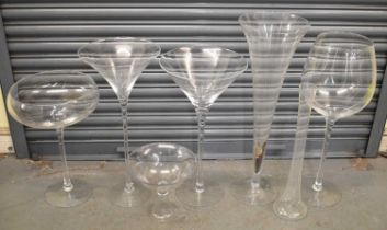 A huge oversized wine glass, height 73.5cm, also three further oversized glasses, two vases and a