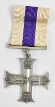 A WWII Military Cross, the reverse engraved 'Capt Alan Edward McGuinness A.M.F. 1943'.