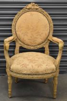 A French fauteuil with elborate detailed back and ram's head scrolling arms with padded back and