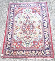 A hand knotted Persian red ground woollen Qom rug, 170 x 105cm.