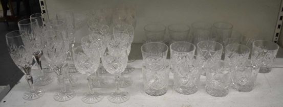 A quantity of cut glass drinking glasses including whisky tumblers, champagne flutes, wine glasses