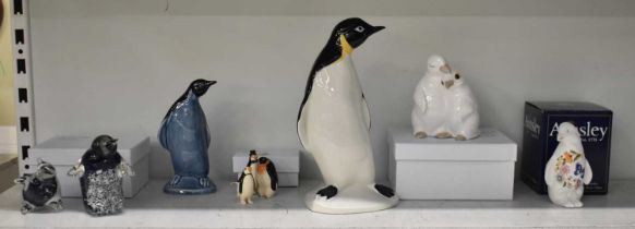 A collection of ten assorted ornamental figures of penguins including large tall example, height