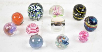 A group of eleven decorative Art Glass paperweights.