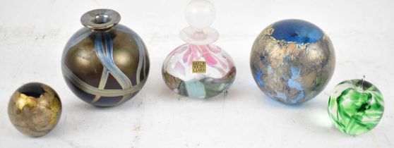 Four Isle of Wight paperweights with an Isle of Wight perfume bottle.