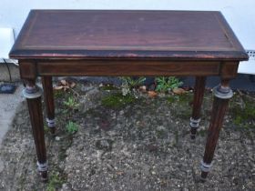 A 19th century simulated rosewood and brass inlaid rectangular fold over card table raised on fluted