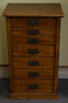 An early 20th century walnut seven drawer Wellington chest with side locking arm and plinth base,