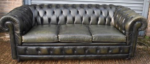 A green leather button upholstered three seater Chesterfield sofa, width approx. 205cm.