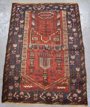 A handmade woollen Baluchi rug, 108 x 77cm.