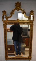 A reproduction decorative gilt framed wall mirror, height 124cm.