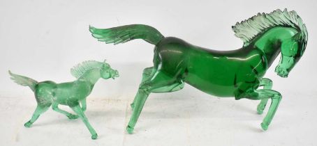 Two green glass models of horses, the largest length approx. 64cm.