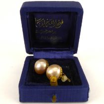A pair of Mabe pearl earrings on yellow metal backs and clips, diameter approx 1.4cm.