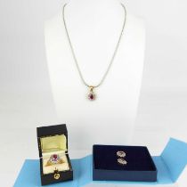 A suite of 9ct diamond and ruby jewellery consisting of pendant on chain, ring, pair of earrings,