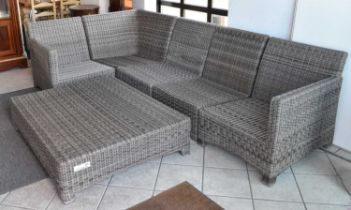 A modern wickerwork L-shaped garden sofa with matching footstool.