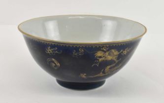 An 18th century Chinese porcelain blue glazed bowl, gilt painted to the exterior with two dragons