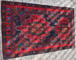 A hand knotted woollen Baluchi rug, 158 x 90cm.