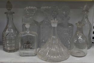 A group of eight cut glass decanters.