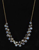 A yellow metal moonstone set necklace.