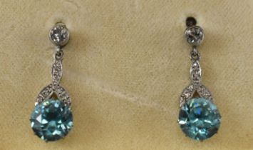 A pair of white metal diamond and zircon drop earrings.