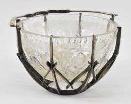 A cut glass bonbon dish housed in decorative white metal frame with swing handle, diameter 12.5cm.