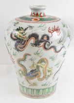 A Chinese porcelain vase decorated with dragons, with a six character mark to base, height 33cm.