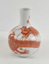 A 20th century Chinese porcelain iron red painted bottle vase decorated with a dragon pursuing a