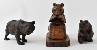 A Black Forest carved standing bear, length 16cm, a seated bear, height 9cm and another example