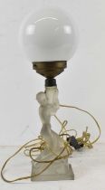 An Art Deco frosted glass table lamp modelled as a nude female with white opaque globe above, height