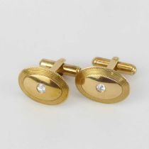 A pair of gentleman's yellow gold oval diamond inset cufflinks with swivel bar backs, the rubover