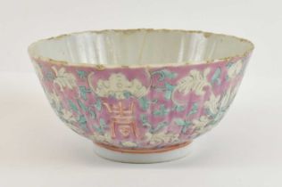 A late 19th century Chinese porcelain ribbed bowl painted in enamels with lotus blooms, bats and