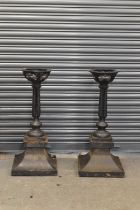 A pair of substantial cast iron street lamp bases, height 94cm.