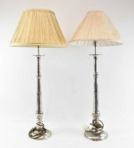 A pair of modern stainless steel table lamps with cream shades, height to top of fitment 72cm.
