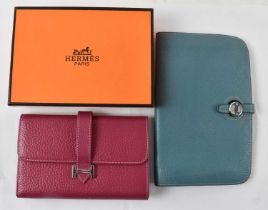 HERMÈS; a boxed pink leather wallet and a further Hermès blue leather wallet, 19.5 x 12.5cm.