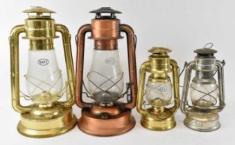 Four assorted hurricane lamps.