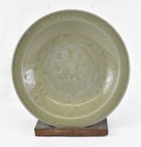 An 18th century Persian celadon glazed shallow circular bowl with floral decoration throughout,