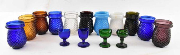 A collection of eleven glass tealights and four small glass footed cups.