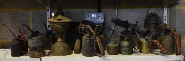 A group of five flame burners, an oil lamp, jug, hurricane lamp and seven oil cans (15).