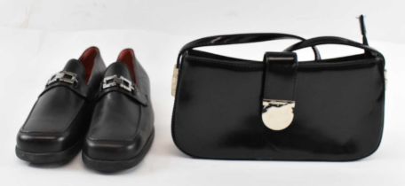 FERRAGAMO; a lady's black leather evening bag and matching pair of size 38 black leather loafers.