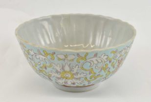 A late 19th century Chinese porcelain ribbed bowl painted in enamels with lotus blooms, bats and
