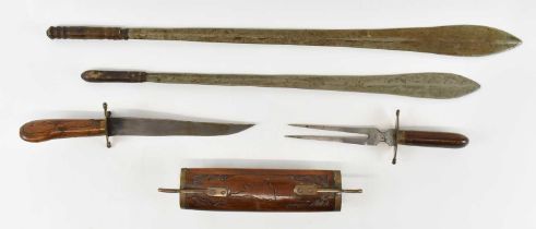 Two Middle Eastern swords, together with a Middle Eastern fork and knife carving set.