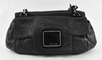 CALVIN KLEIN; a black leather handbag with shoulder strap and two lift-up pockets, 40 x 26cm.