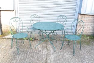 A green painted wrought iron circular garden table, diameter 96cm, together with four matching green