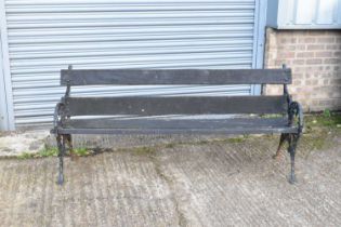 A late 19th century black painted and cast iron garden bench, width 176cm.