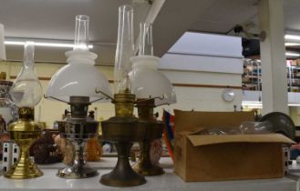 A pair of brass oil lamps and two others, with three extra chimneys and various boxed wicks.