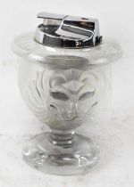 LALIQUE; a French glass table lighter depicting lions' faces, height 11.5cm.