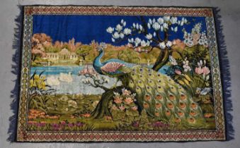 A 20th century wall hanging rug depicting a peacock amongst foliage, 124 x 185cm.