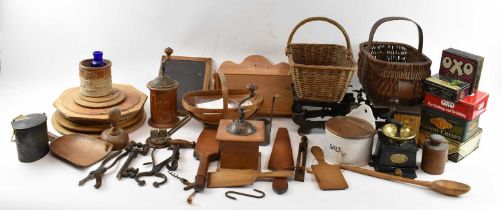 A collection of kitchenalia, including scales, baskets, breadboards, tins, a knife rack, pan, sieve,