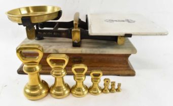 J. BANFIELD LTD OF BRIGHTON; a set of 19th century brass balance scales, on wooden base with