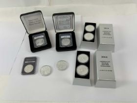 A cased 2014 American Eagle silver dollar coin set comprising two one ounce silver dollars, a 2011